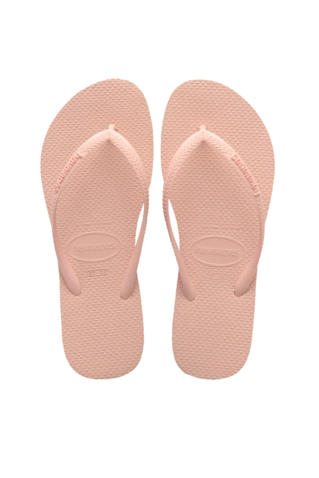 Havaianas klipklapper i lys rosa med "havaianas" på remmen og en tekstureret overflade.