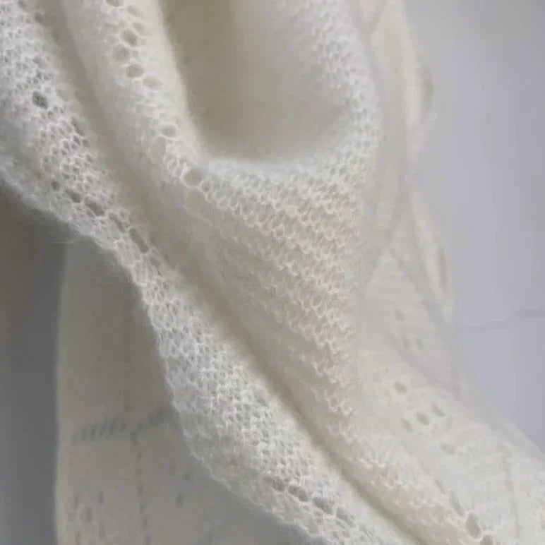 Detalje af hvidt cashmeretørklæde fra Andcopenhagen Basics, trekantformet og strikket i 100% cashmere.