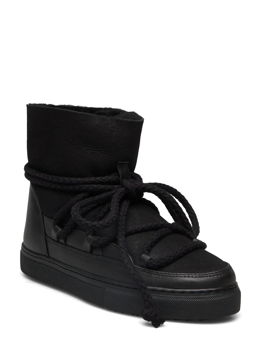 Sort vinterstøvle med højt skaft, tykke snørebånd og flad, mønstret sål. Mærke "INUIKII" synligt.