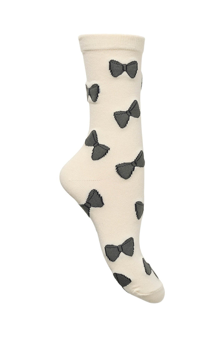 Lollys Laundry BowLL Socks in creme color with black bow patterns, made of cotton blend, shown on a mannequin foot.