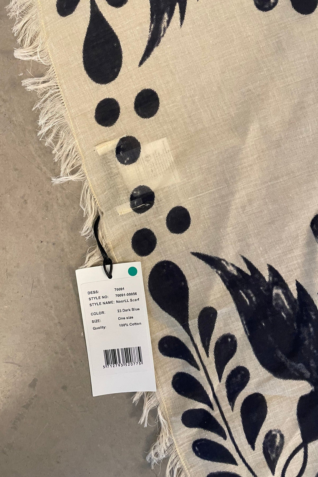 Lollys Laundry NoorLL Scarf in 23 Dark Blue, featuring a floral pattern on a cotton fabric with fringed edges, shown flat.