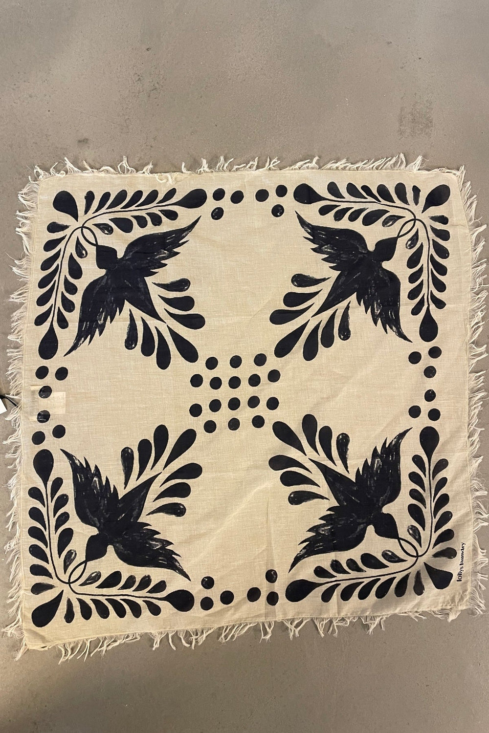 Lollys Laundry NoorLL Scarf in 23 Dark Blue, a square cotton scarf with a bird and foliage print, shown flat.