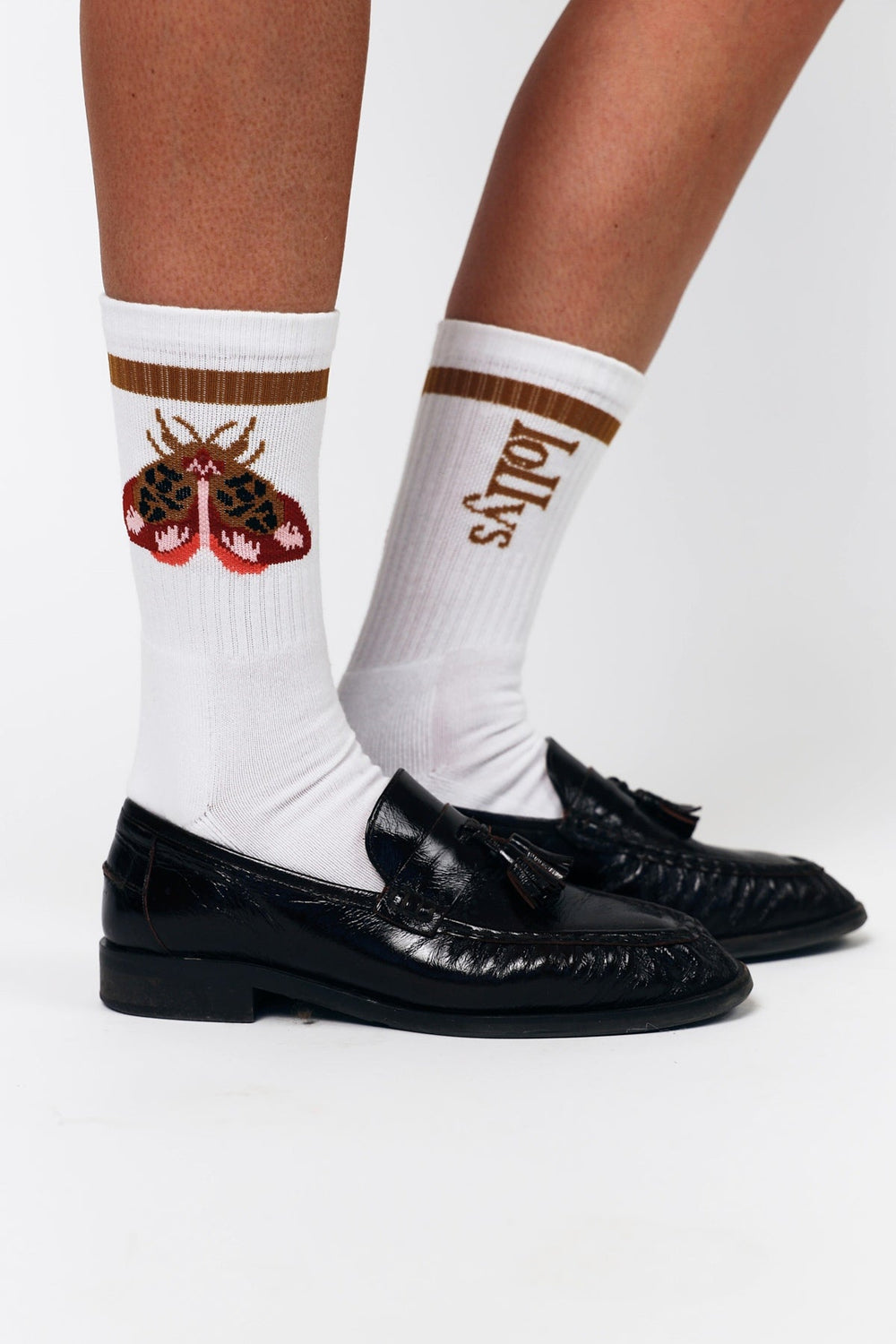 Lollys Laundry RowanLL Socks in 54 Rust color, featuring a striped design with a moth motif, worn by a model with black loafe