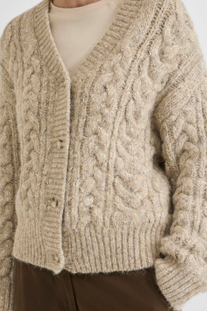 Vila ROUELLIS L/S Knit Cardigan in Pelican color, featuring a cable knit pattern, V-neck, and button closure, worn by a model