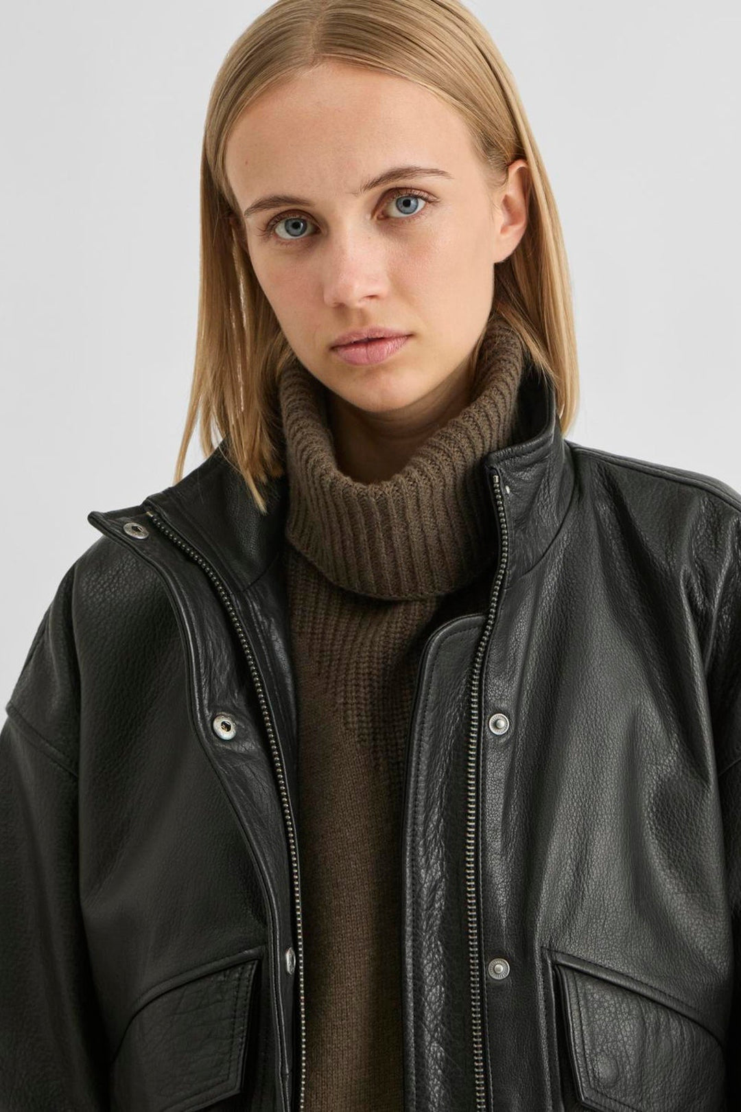 Vila ROUSIMONE oversized leather jacket in meteorite black, shown worn by a model, featuring a biker collar and long sleeves.