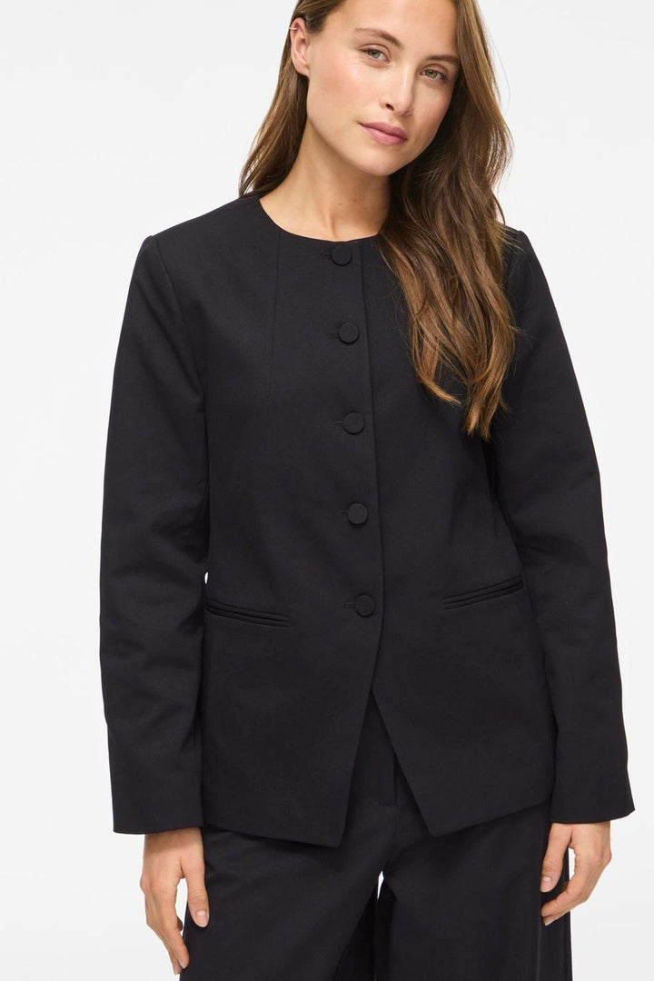 Vila Vichiona long sleeve black blazer made of polyester, featuring a round neckline and button closure, worn by a model.